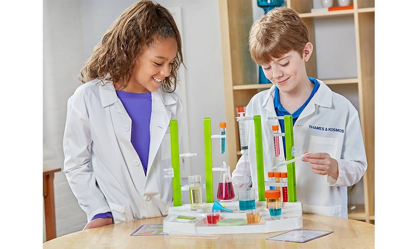 Kids playing with chemistry station experiment kit
