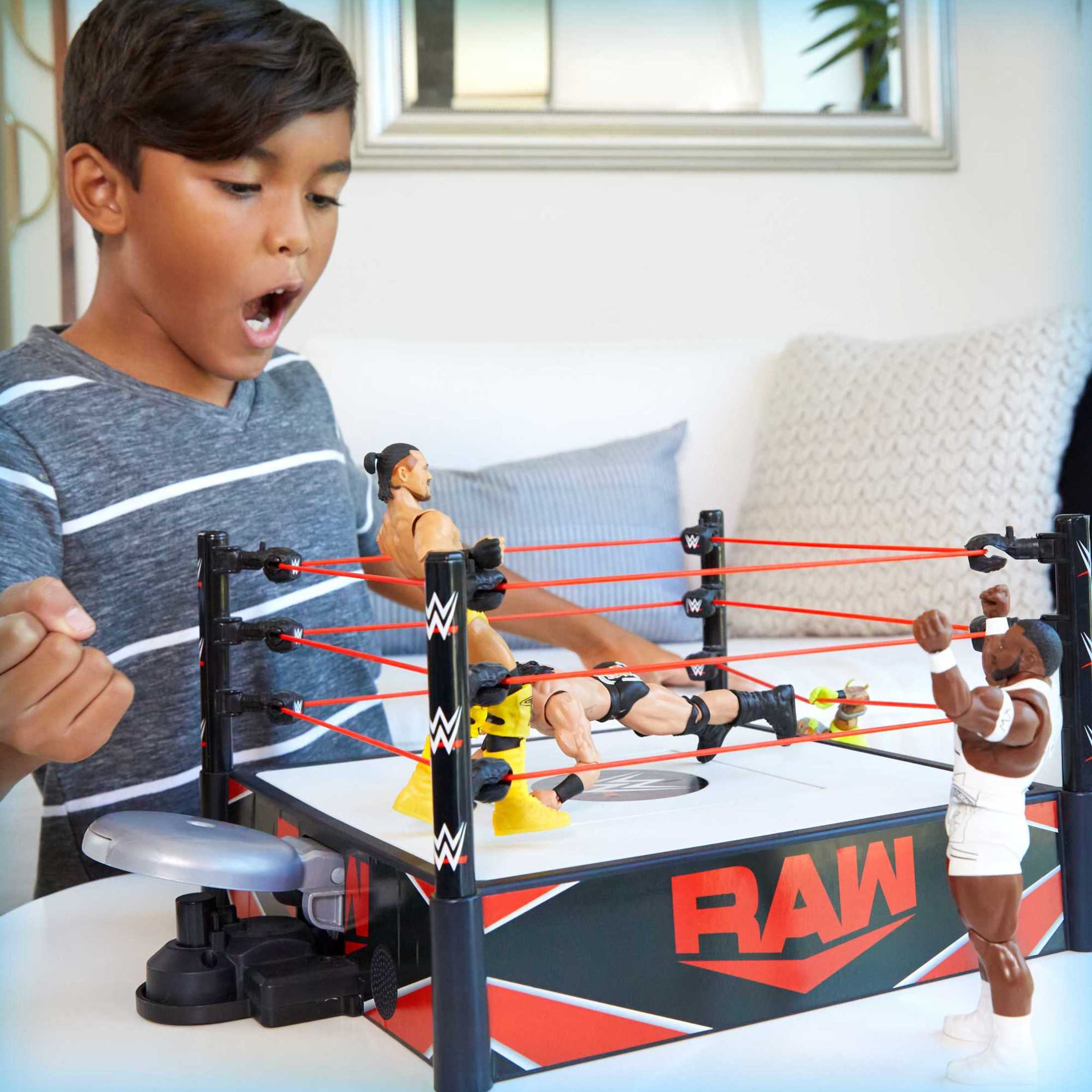 WWE action figures battling in the Wrekkin' Kickout Ring.
