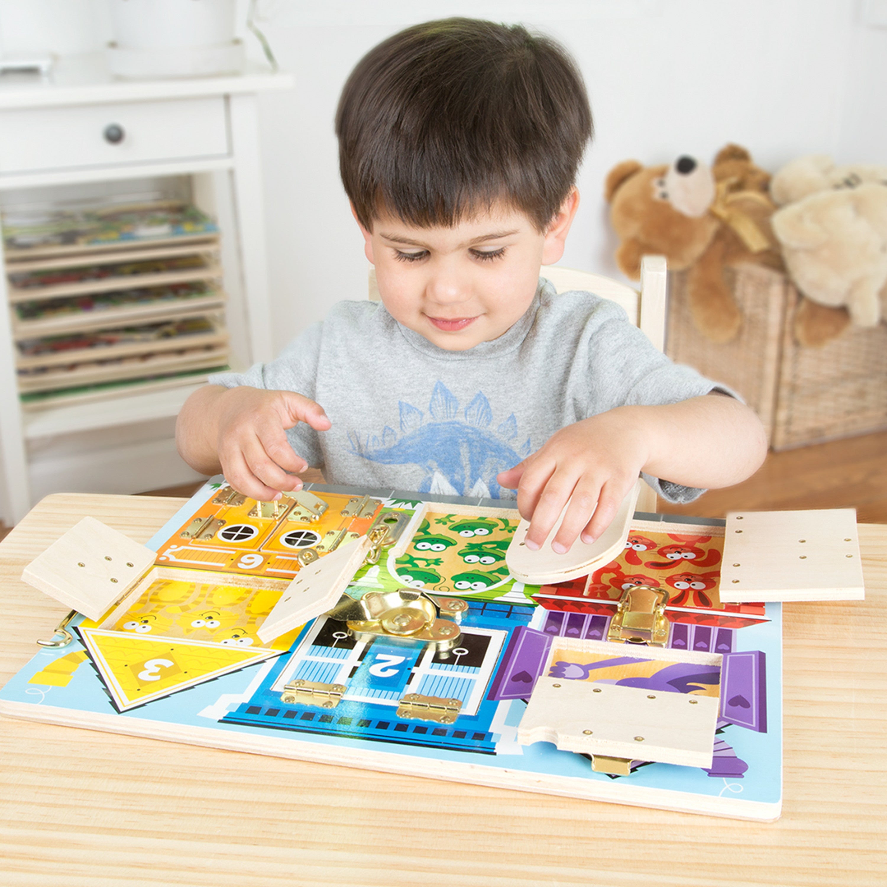 Preschooler practicing motor skills with latches and locks
