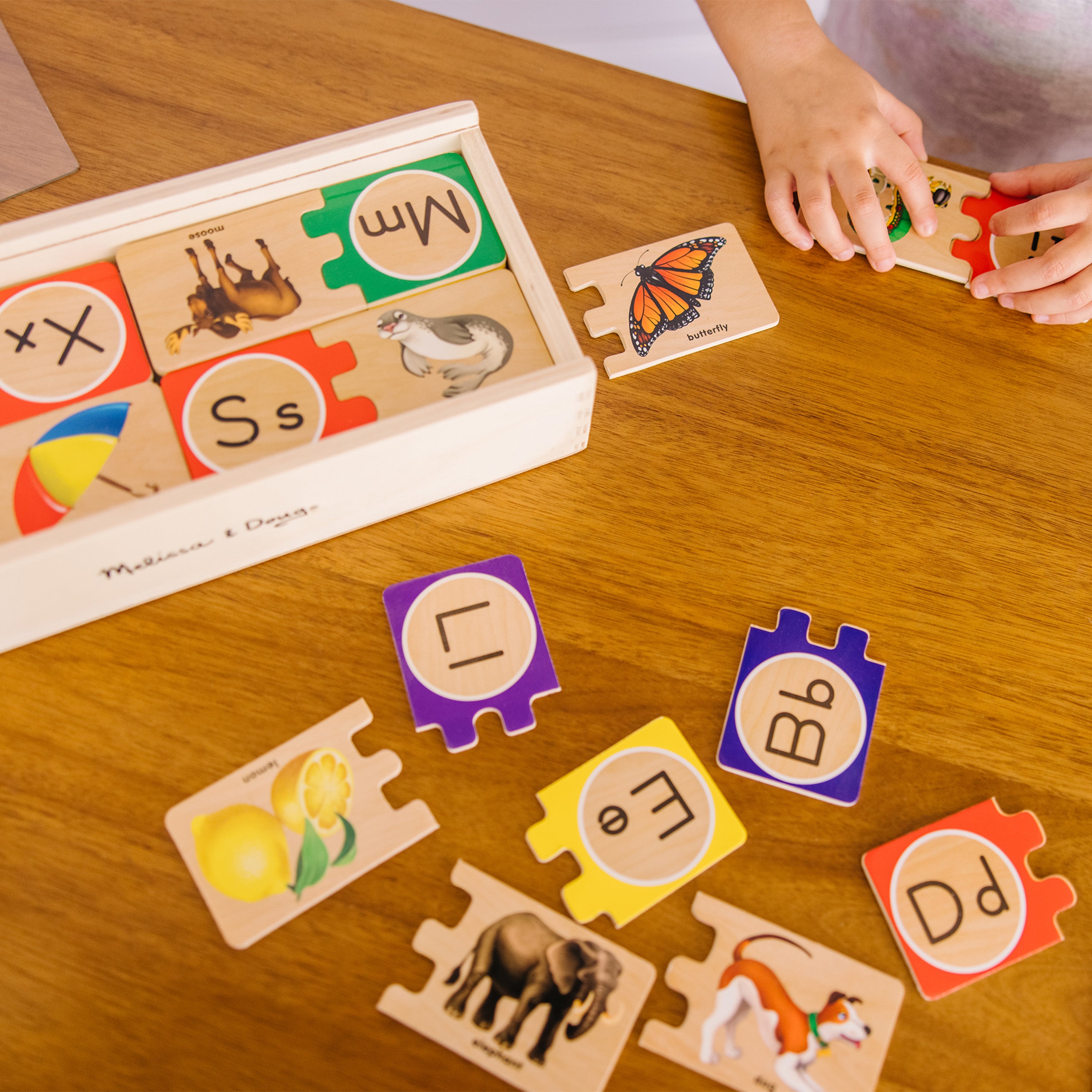 Storage box with colorful alphabet puzzle pieces
