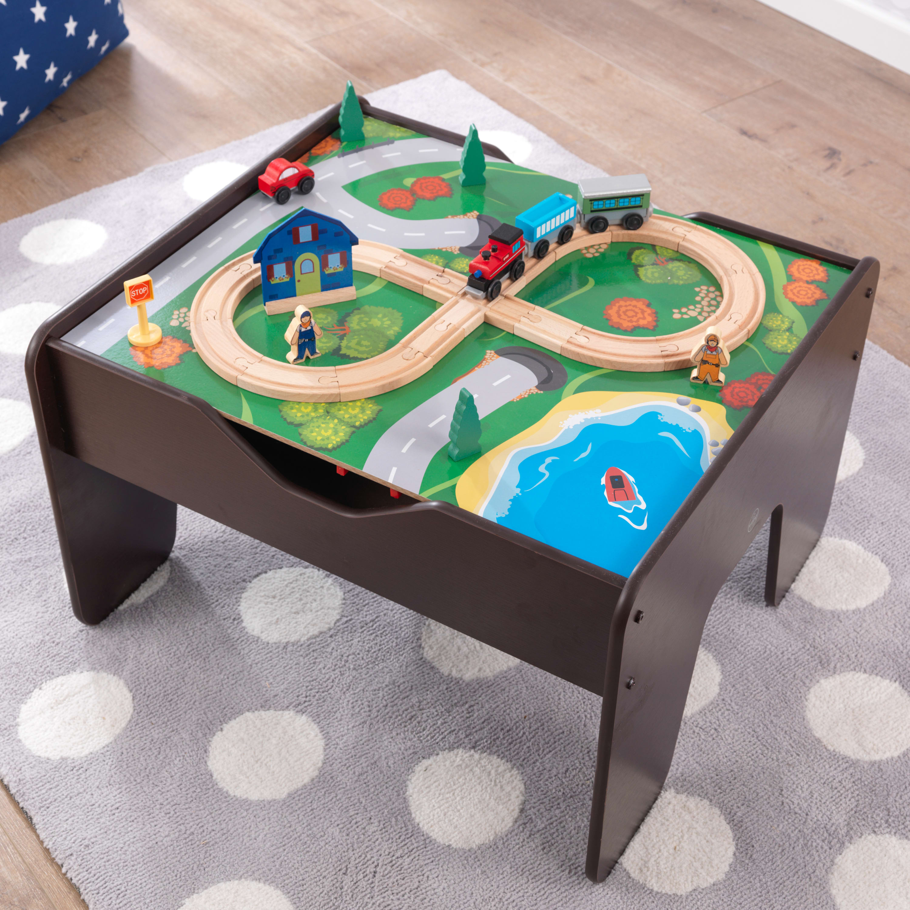 Child playing with train set on the KidKraft Activity Table
